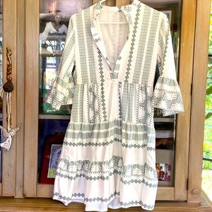 Mid length mainly white with green design dress